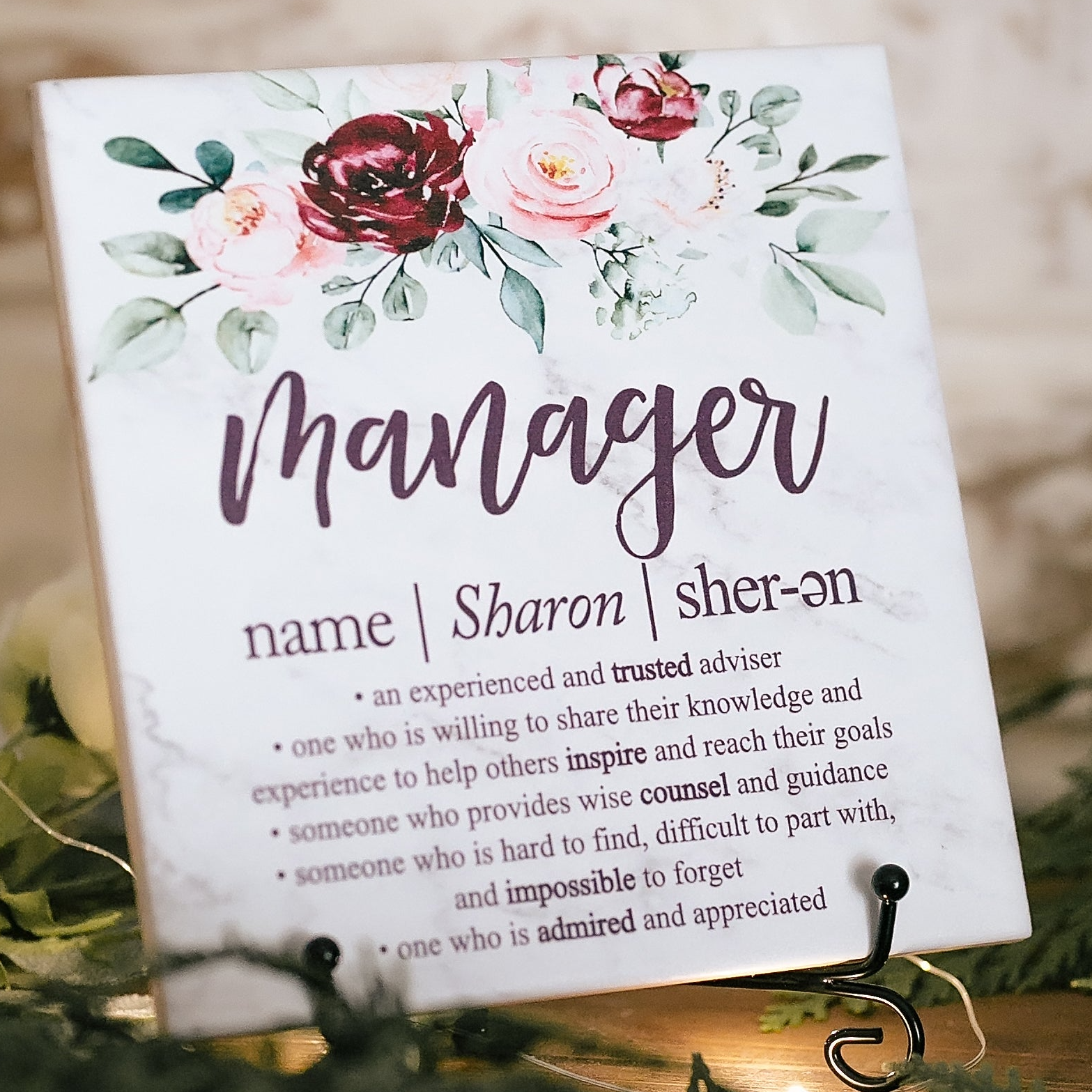 a close up of a sign with flowers on it