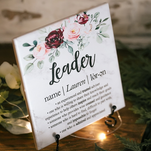 a sign that says leader with flowers on it