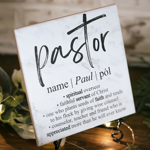 a wooden table topped with a sign that says pastor