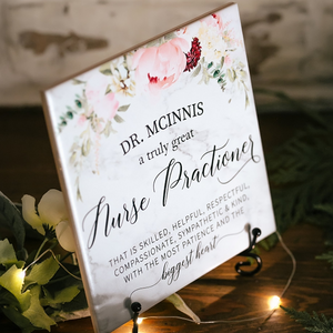 a sign with flowers on it sitting on a table