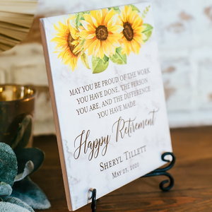 a sign with a sunflower on it sitting on a table
