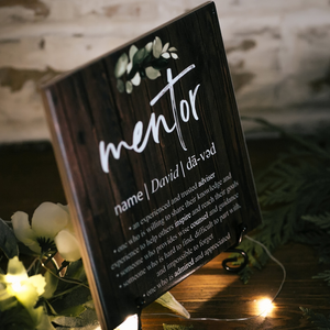 a wooden sign sitting on top of a wooden table