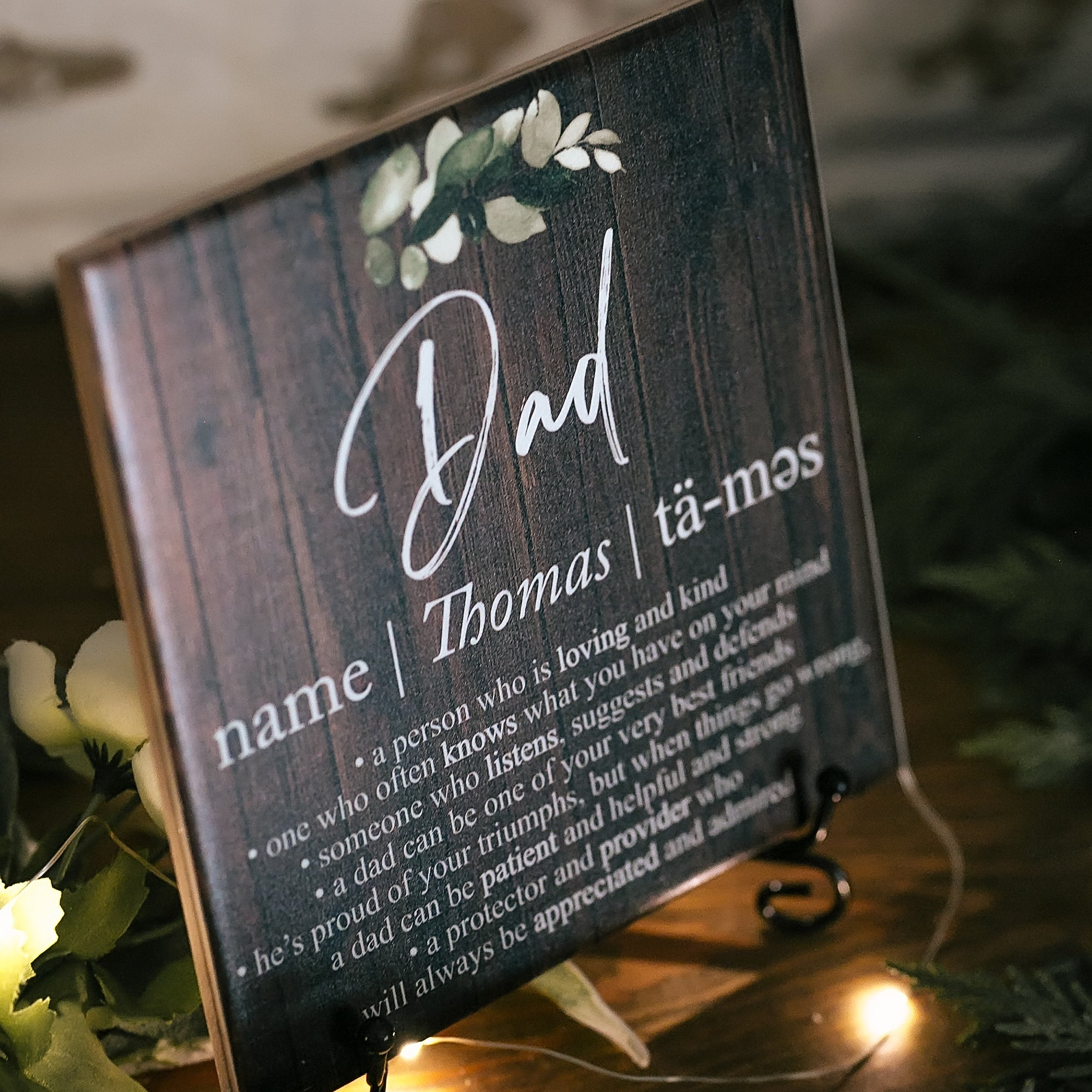 a wooden sign with a name and a picture on it