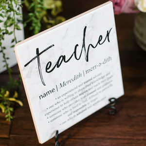 a sign on a table that says teacher