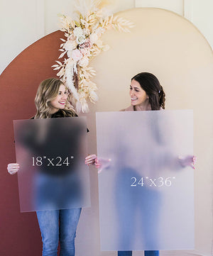 a couple of women standing next to each other holding signs